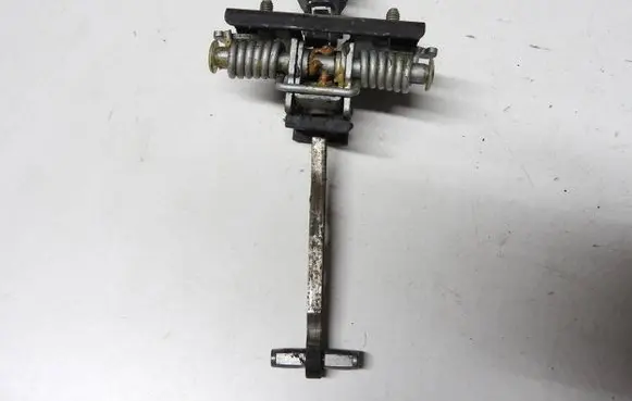 Front door check strap stopper