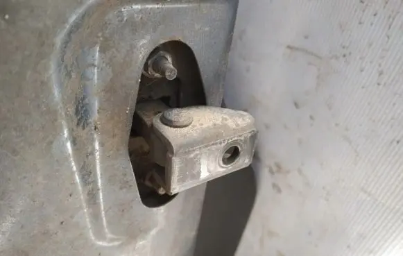 Front door check strap stopper