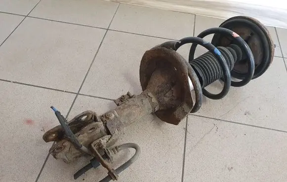 Mitsubishi Lancer VIII Front shock absorber with coil spring