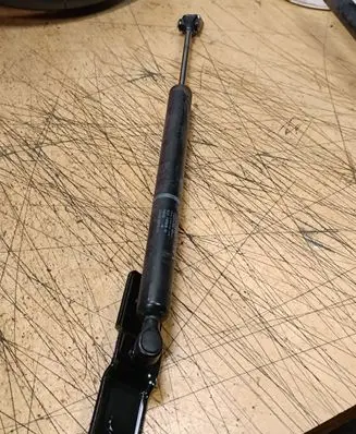 Front door check strap stopper