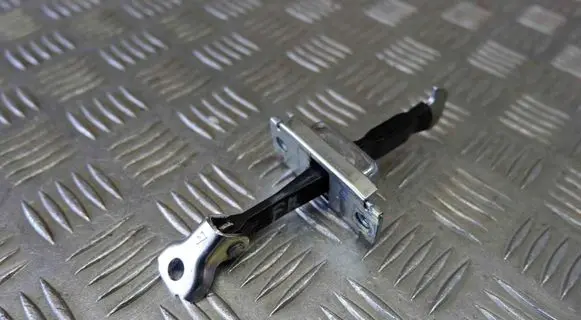 Front door check strap stopper