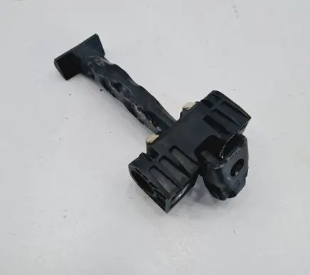 Front door check strap stopper