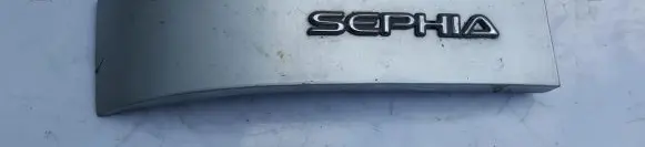 KIA Sephia Rear/tail light trim molding 0k201512f0