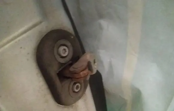 Front door check strap stopper