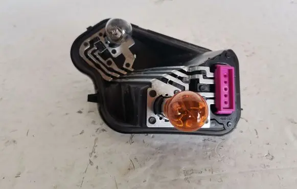 Tail light bulb cover holder