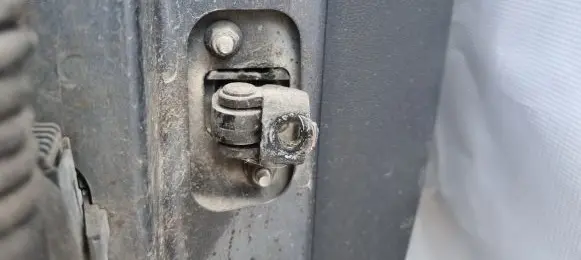 Front door check strap stopper
