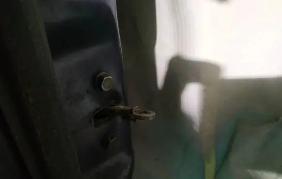Front door check strap stopper