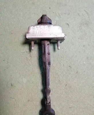 Front door check strap stopper