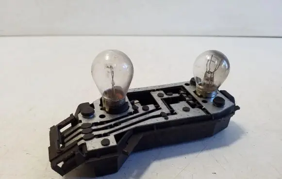 Tail light bulb cover holder