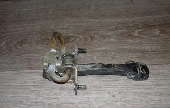 Front door check strap stopper