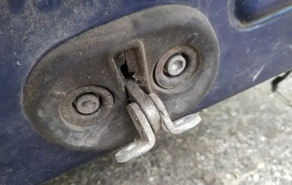 Front door check strap stopper