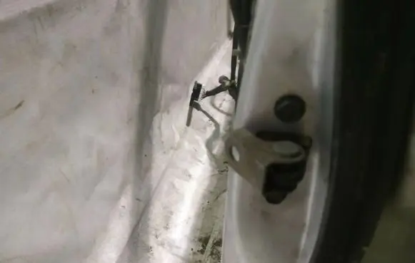 Front door check strap stopper