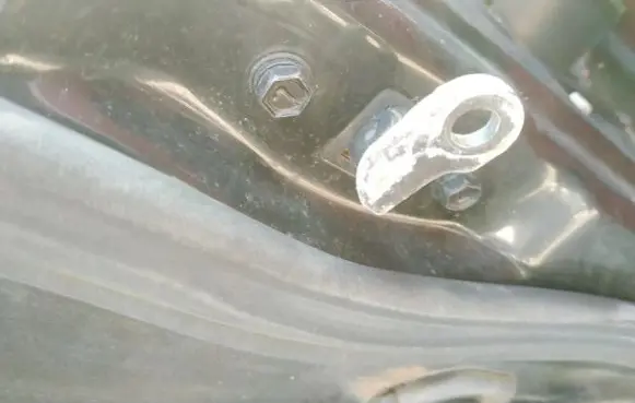 Front door check strap stopper