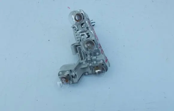 Tail light bulb cover holder