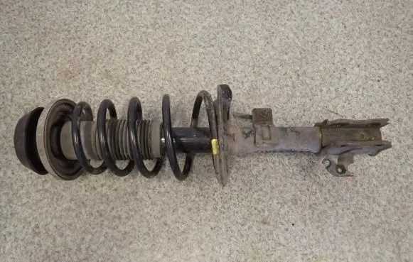 Suzuki Swift I Front shock absorber with coil spring
