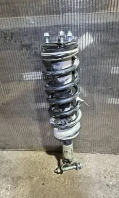 Ram 1500 DT Front shock absorber with coil spring 68277311AC