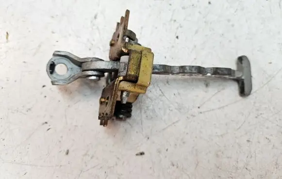 Front door check strap stopper