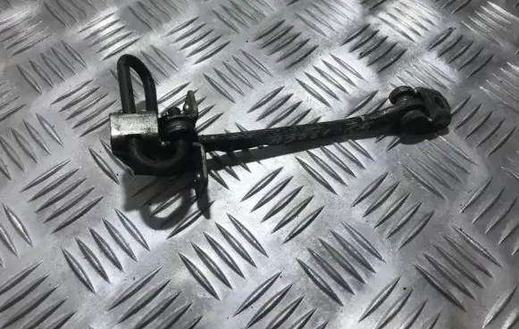 Front door check strap stopper