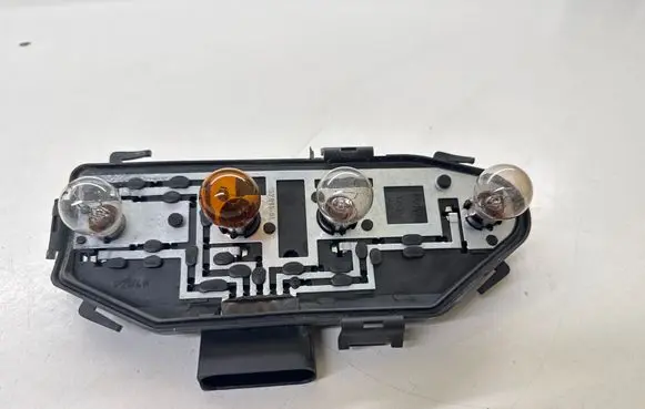 Tail light bulb cover holder