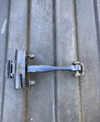Front door check strap stopper