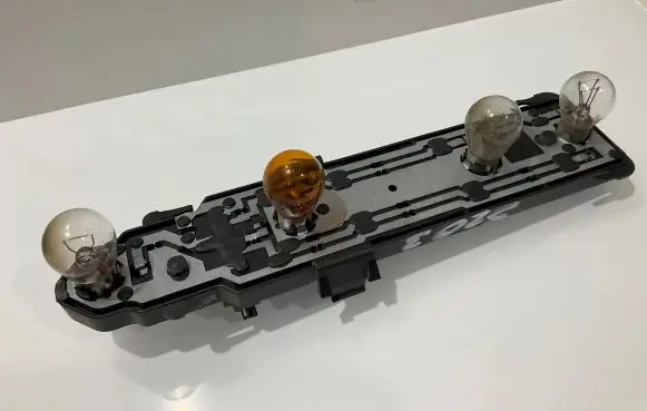 Tail light bulb cover holder