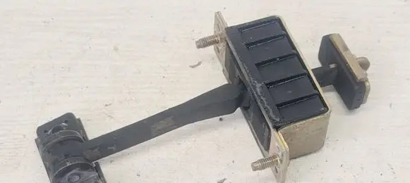 Front door check strap stopper