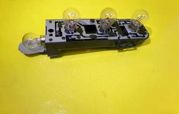 Tail light bulb cover holder