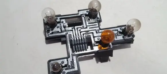 Tail light bulb cover holder