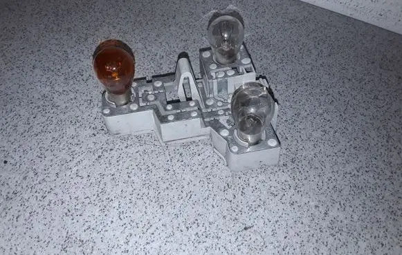 Tail light bulb cover holder