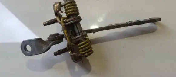 Front door check strap stopper