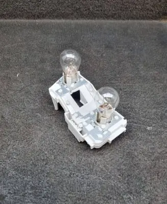 Tail light bulb cover holder
