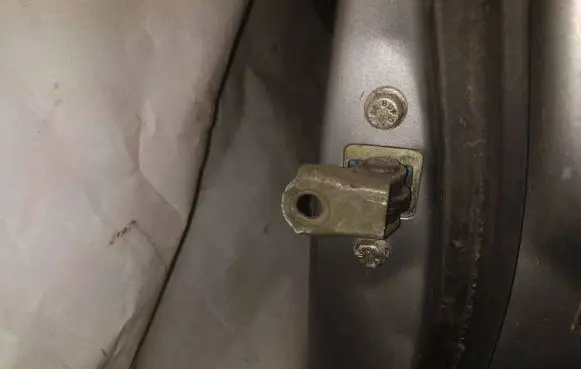 Front door check strap stopper