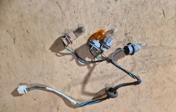 Mazda 323 Tail light bulb cover holder