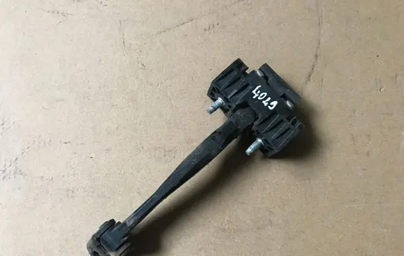 Front door check strap stopper