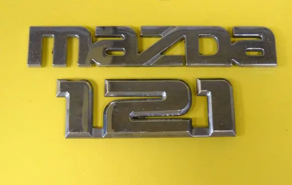 Mazda 121 SM Manufacturers badge/model letters 