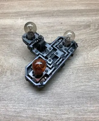 Tail light bulb cover holder