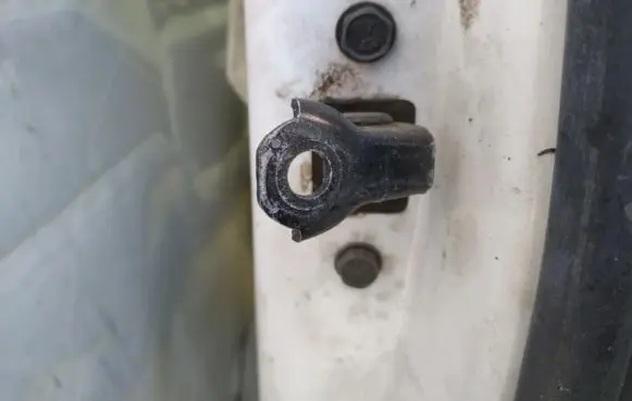 Front door check strap stopper