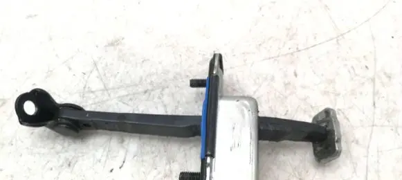 Front door check strap stopper