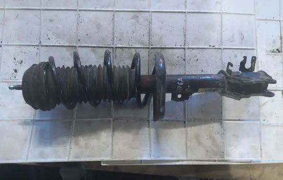 Opel Corsa D Front shock absorber with coil spring 13214354