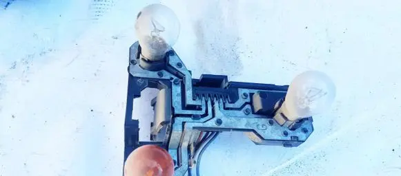 Tail light bulb cover holder