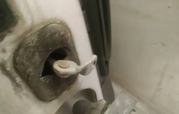 Front door check strap stopper