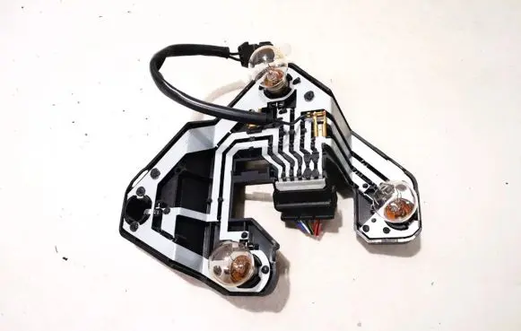 Tail light bulb cover holder