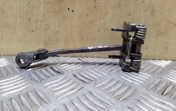 Front door check strap stopper