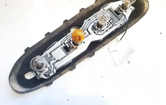Tail light bulb cover holder