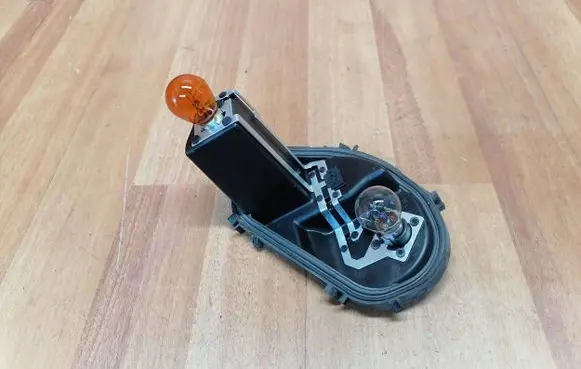 Tail light bulb cover holder