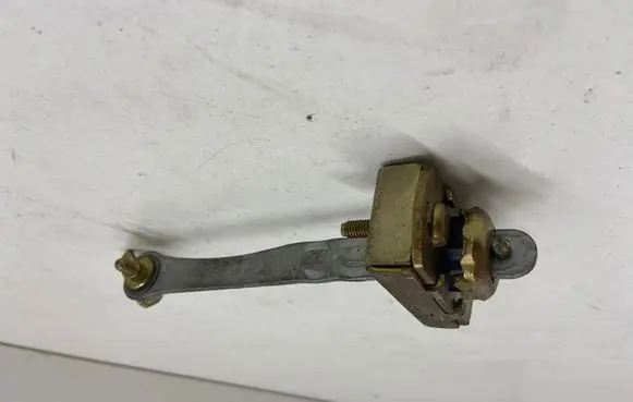 Front door check strap stopper