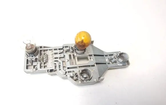 Tail light bulb cover holder