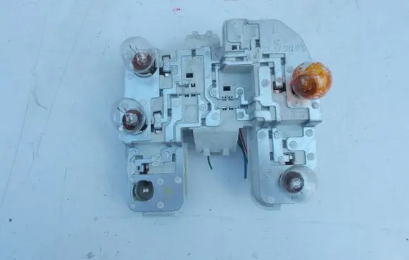 Tail light bulb cover holder