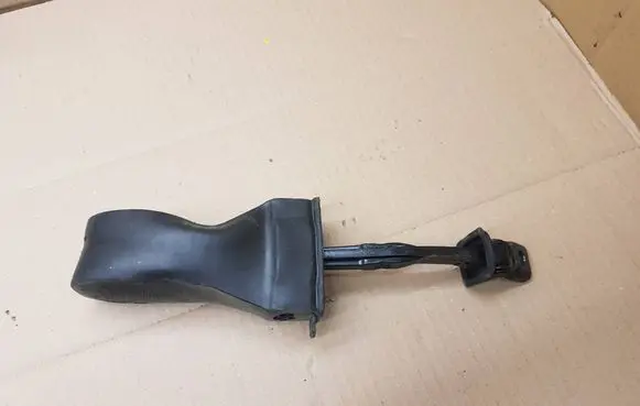 Front door check strap stopper