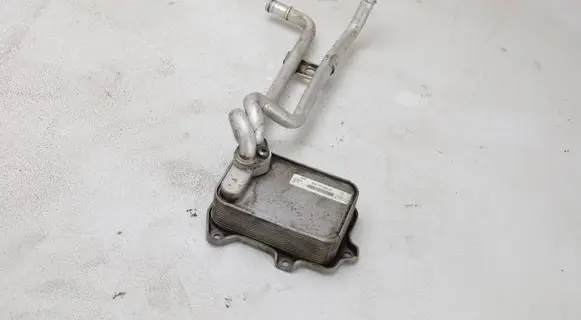 Volkswagen PASSAT B7 Engine oil radiator 03C117021M 03C121050L